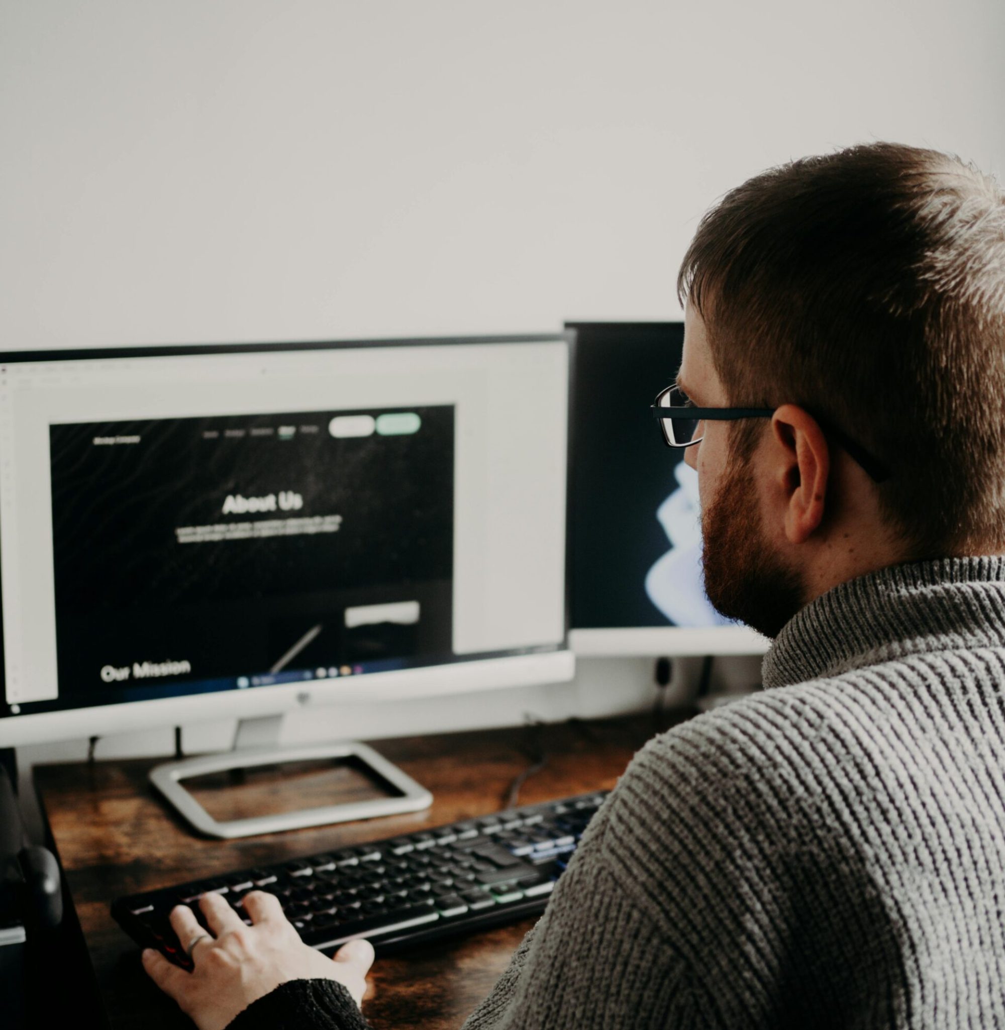 Man in Glasses Working on PC at Table